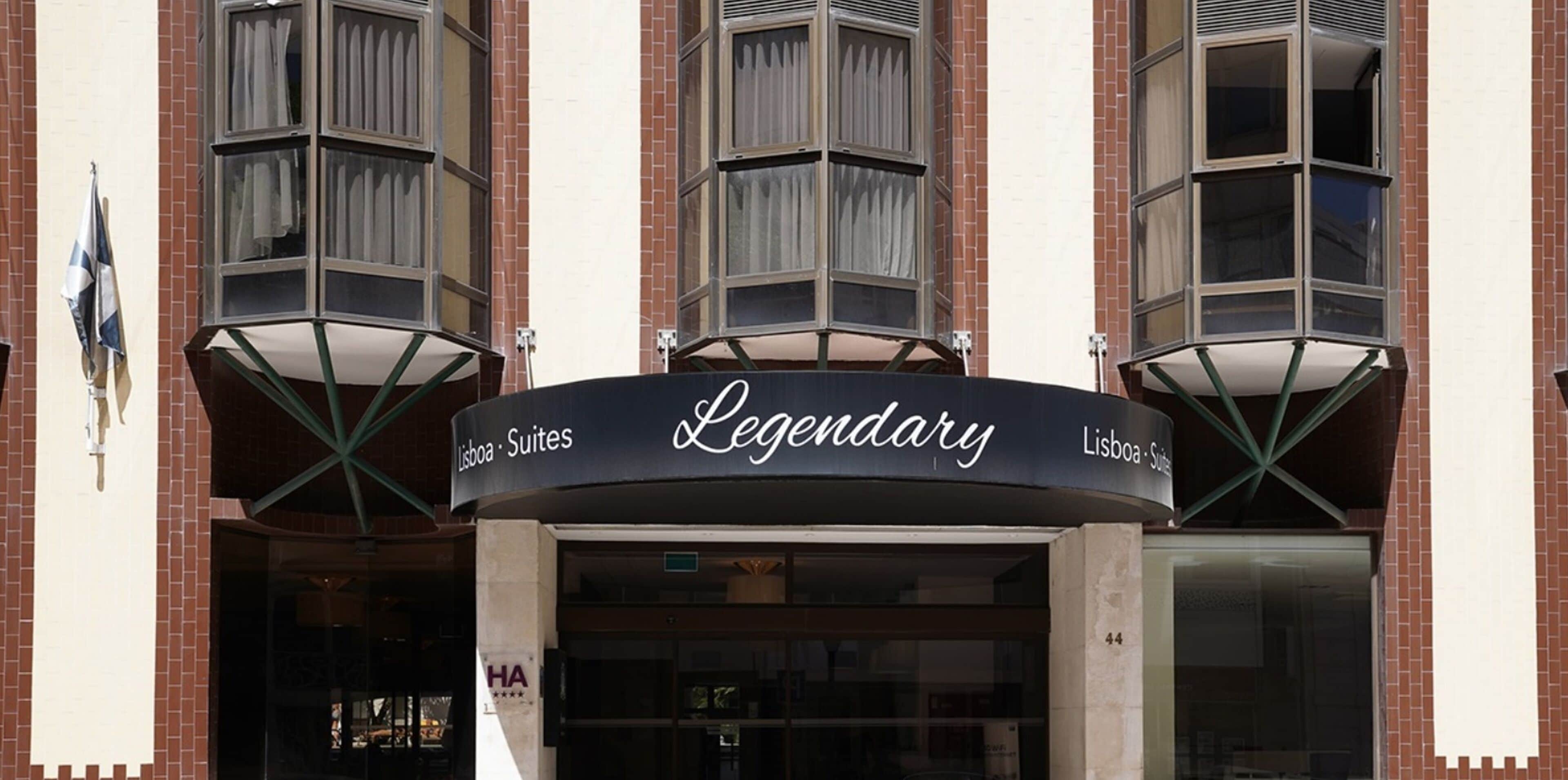 A hotel entrance with a sign reading "Legendary Lisboa Suites."