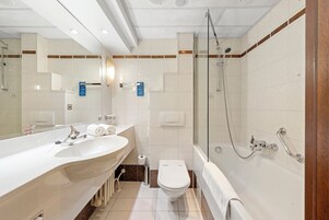 Un bagno moderno con un lavandino grande, un water e una vasca da bagno.