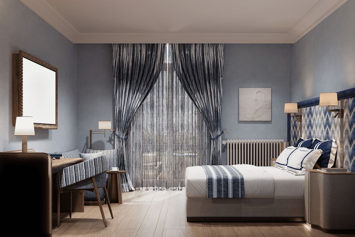 Une chambre à coucher avec un lit, des tables de chevet, un bureau et une chaise.