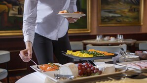 A buffet setup with various food items and utensils.