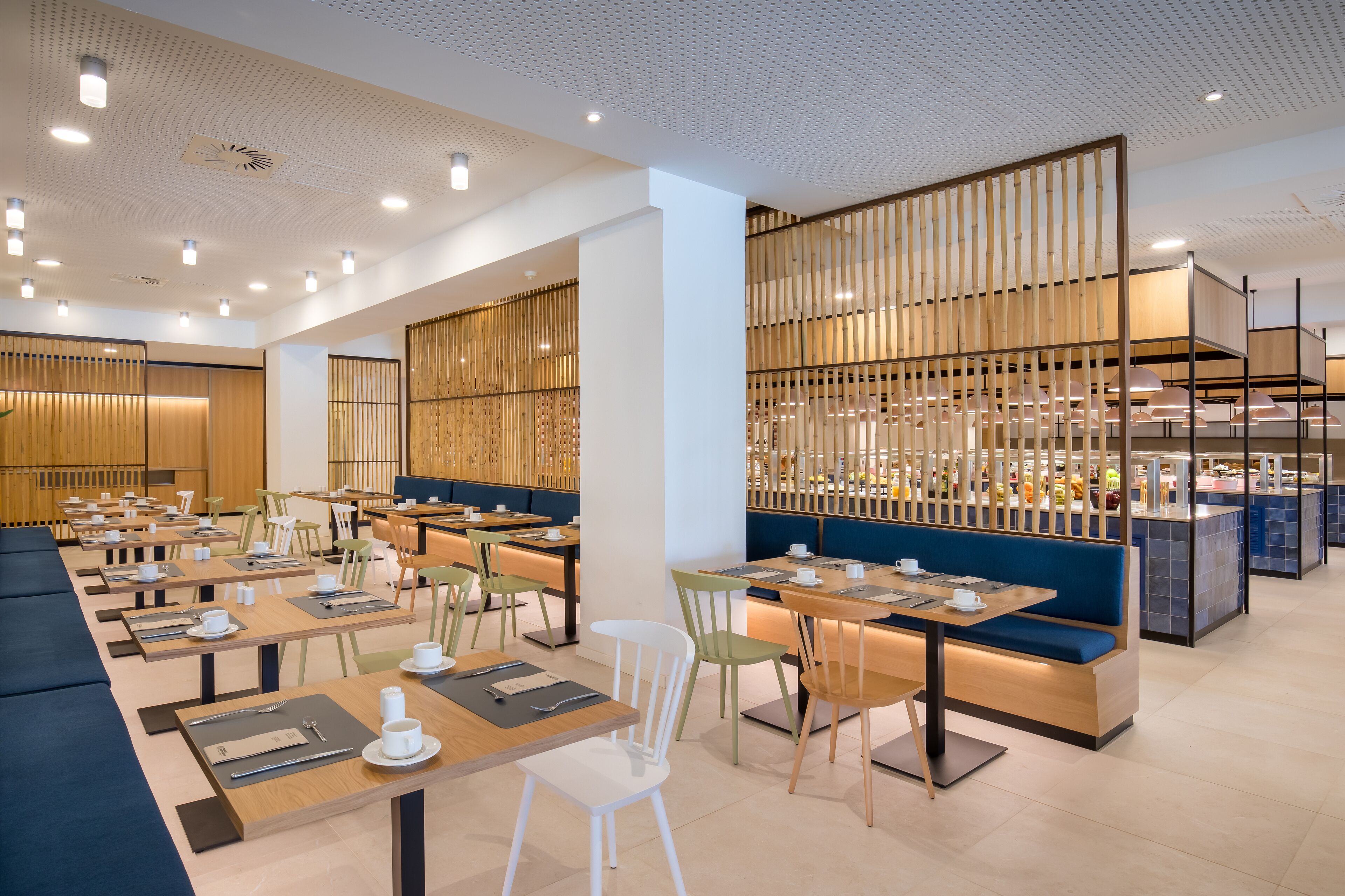 A modern restaurant with multiple dining areas, wooden partitions, and a variety of seating options including tables and booths.