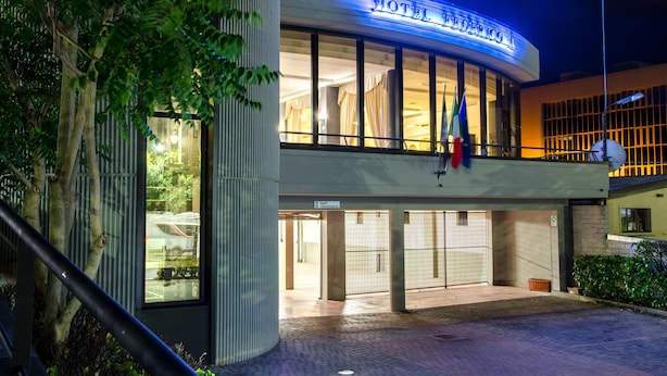 A hotel with a modern facade, large windows, and a sign indicating a restaurant. - Hotel Federico II (L'Aquila)