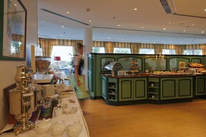 A buffet area with a variety of food items and a buffet station. - GolfResort Semlin (Rathenow)