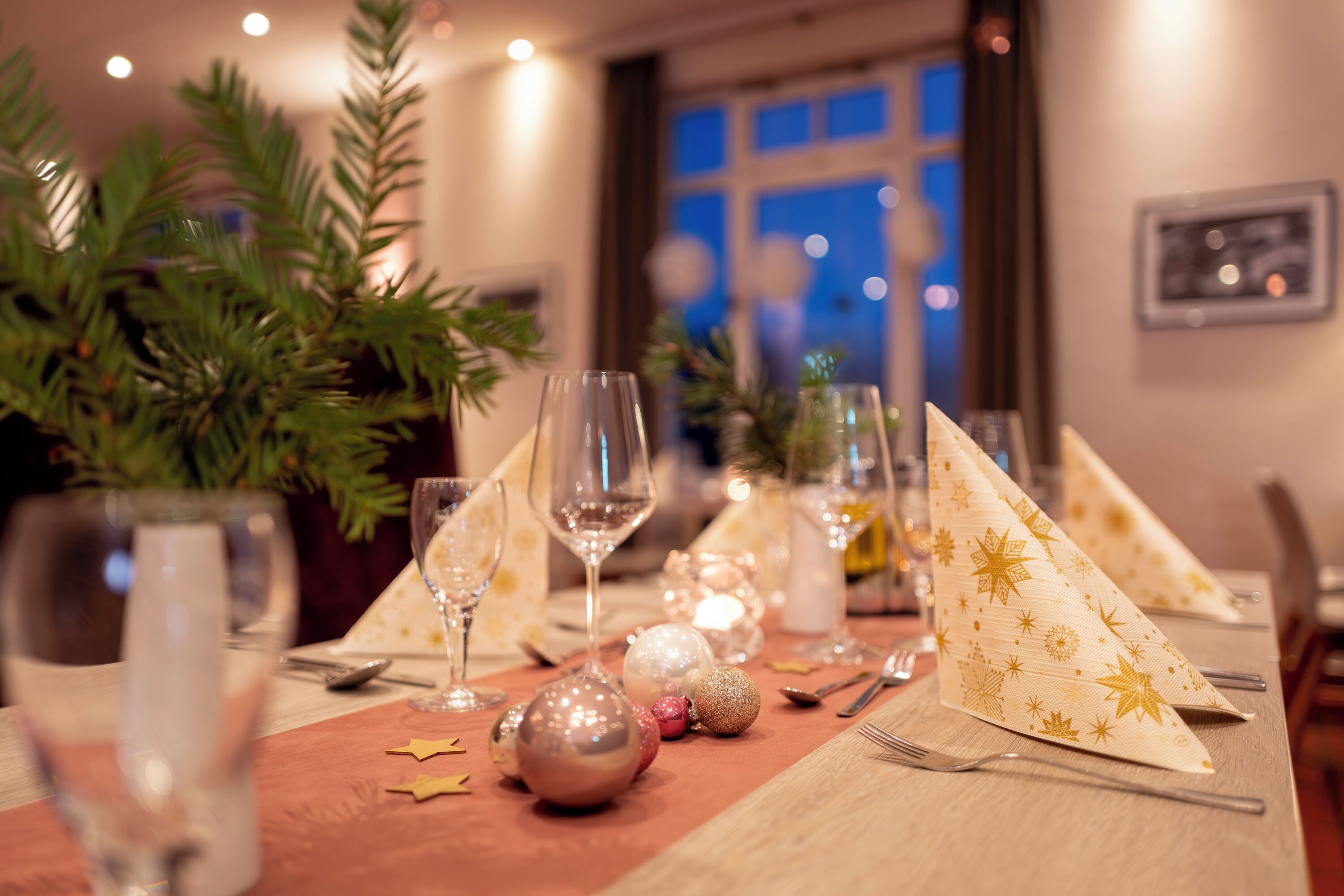A table set for a meal with glassware, plates, and napkins.