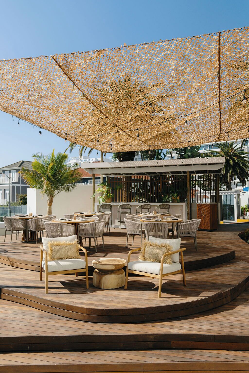 An outdoor seating area with wicker furniture and a canopy.