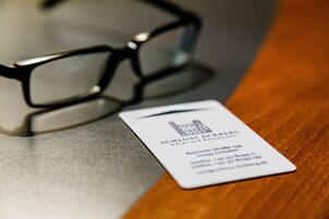 A business card for Schloss Eickberg Hotel and Restaurant, including the address and contact information.