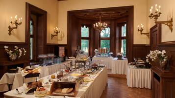 A buffet setup with various food items and a chandelier.
