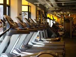 A row of stationary exercise bikes in a gym. - The Alex (Dublin)