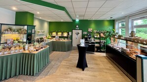 A buffet area with various food items and a coffee station.