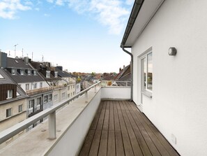 Enjoy the view from this balcony with a view of neighboring buildings and varied architectural styles.