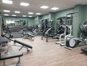 A gym with various exercise equipment, including treadmills, weight machines, and dumbbells. - The Eliott Hotel (Gibraltar)