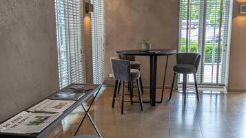 A modern dining area with a table and chairs, a bench, and a newspaper on the table.
