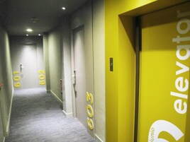 A hotel corridor with doors numbered 601, 602, and 603, leading to rooms.