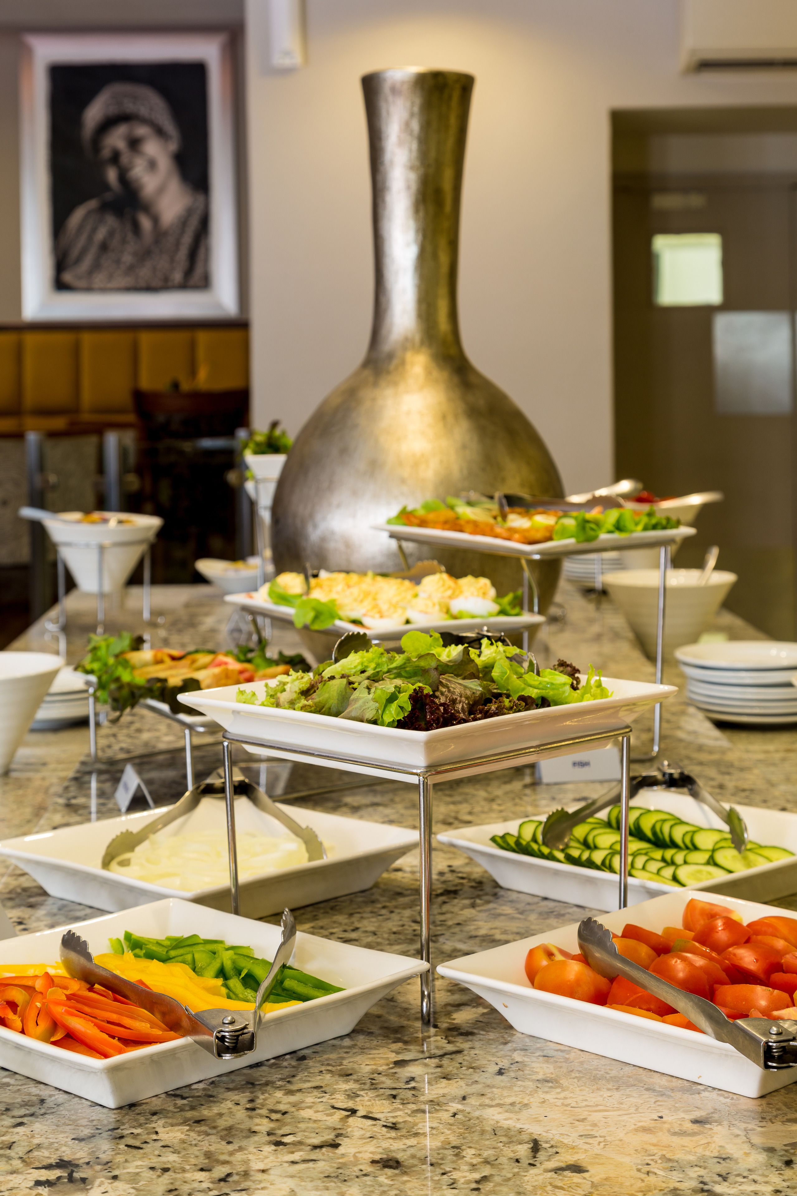 A buffet with various dishes including vegetables and salads.