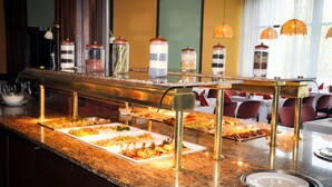 A buffet setup with various food items and condiment dispensers. - Hotel Lövér Sopron (Sopron)