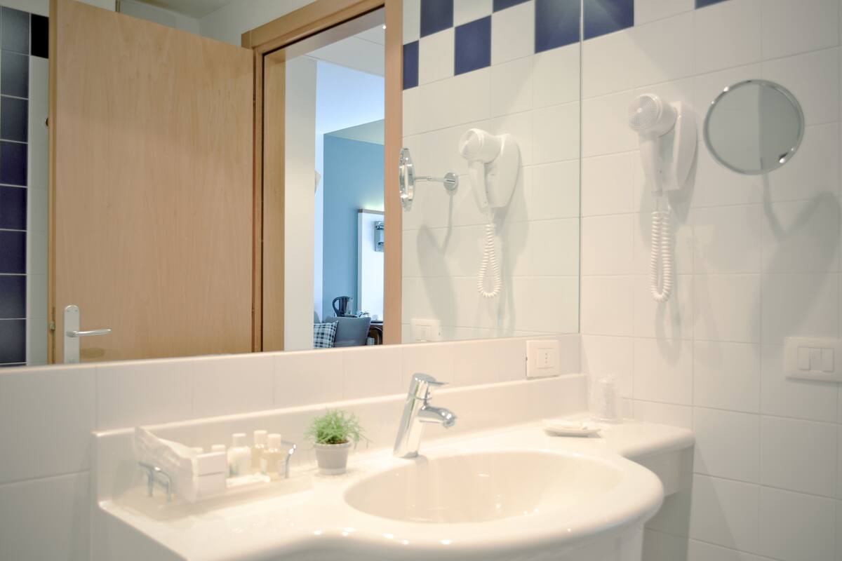 quadruple room | bathroom | shower, free toiletries, hair dryer, slippers