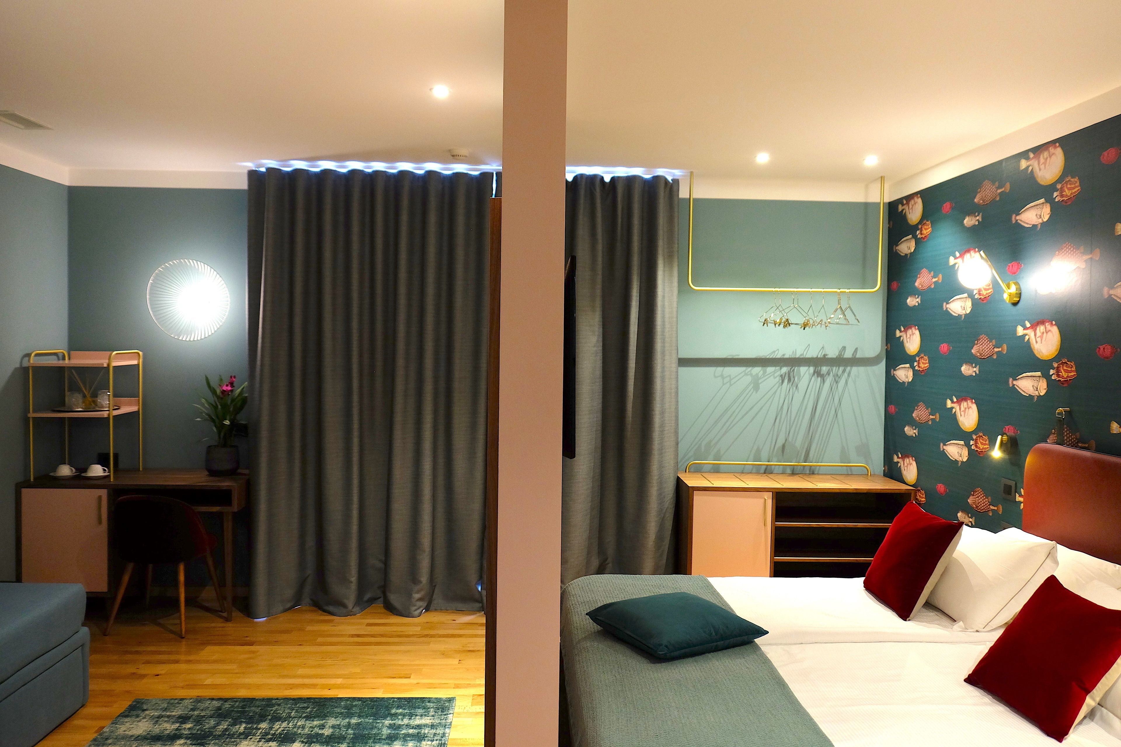 A bedroom with a bed, a desk, and a chair.