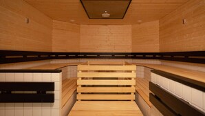 A sauna with wooden benches and tiled walls. - Scandic Aulanko (Hameenlinna)