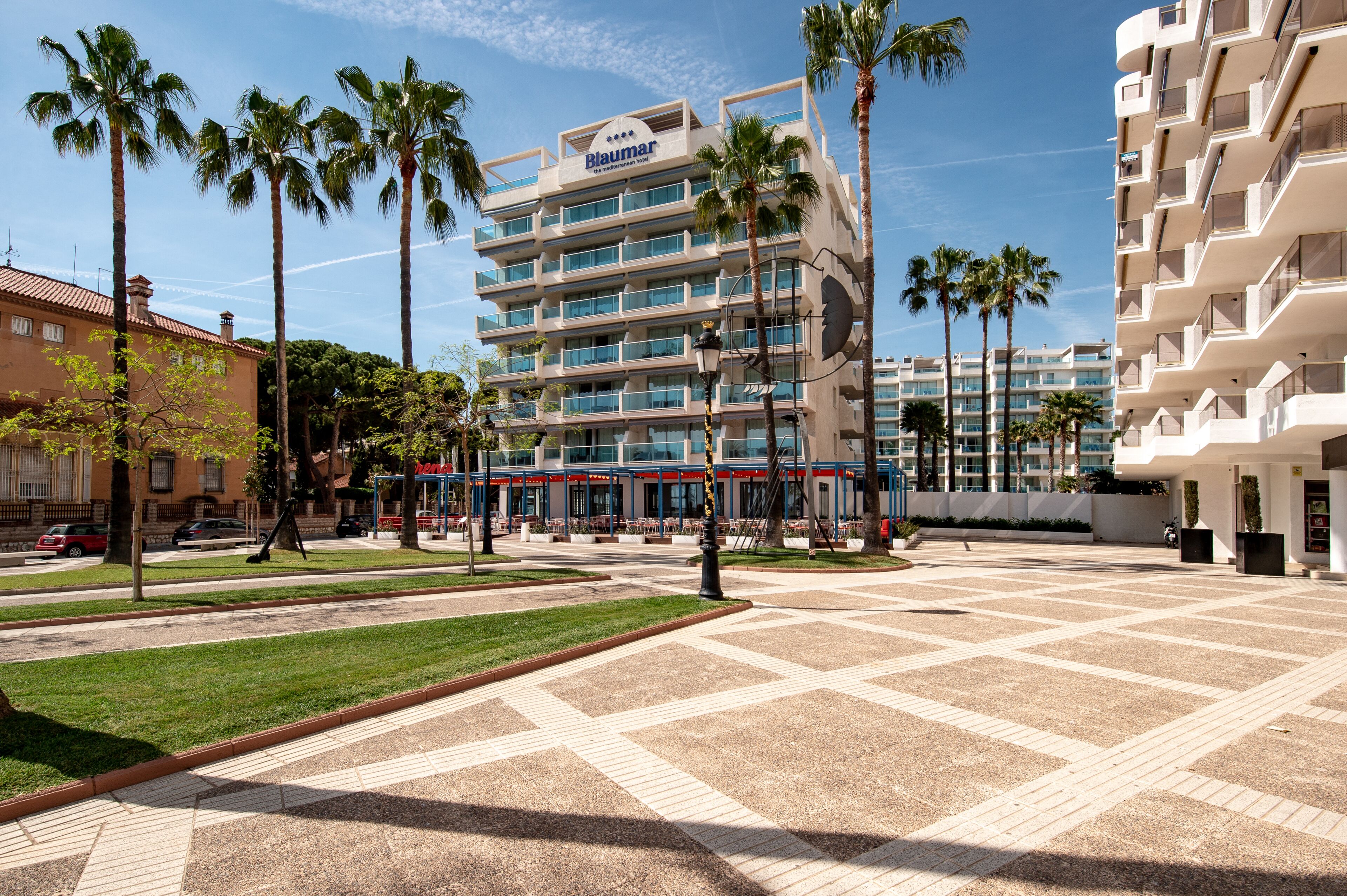 A hotel with a modern design, featuring multiple floors and balconies.