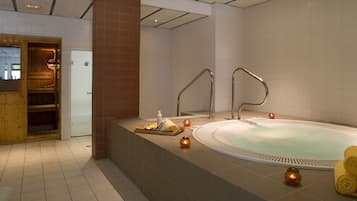 Relax in our serene spa area, featuring a large hot tub and amenities for a rejuvenating experience.