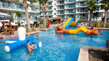 Relax by the pool surrounded by palm trees and enjoy the water play equipment.