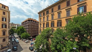 A street view with parked cars and trees lining the road. - Le Méridien Visconti Rome (Rome)