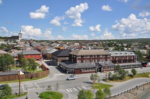 A town with a prominent clock tower, a central roundabout, and a mix of residential and commercial buildings.