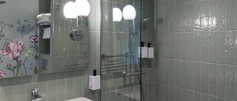 A bathroom with a sink, mirror, and shower.