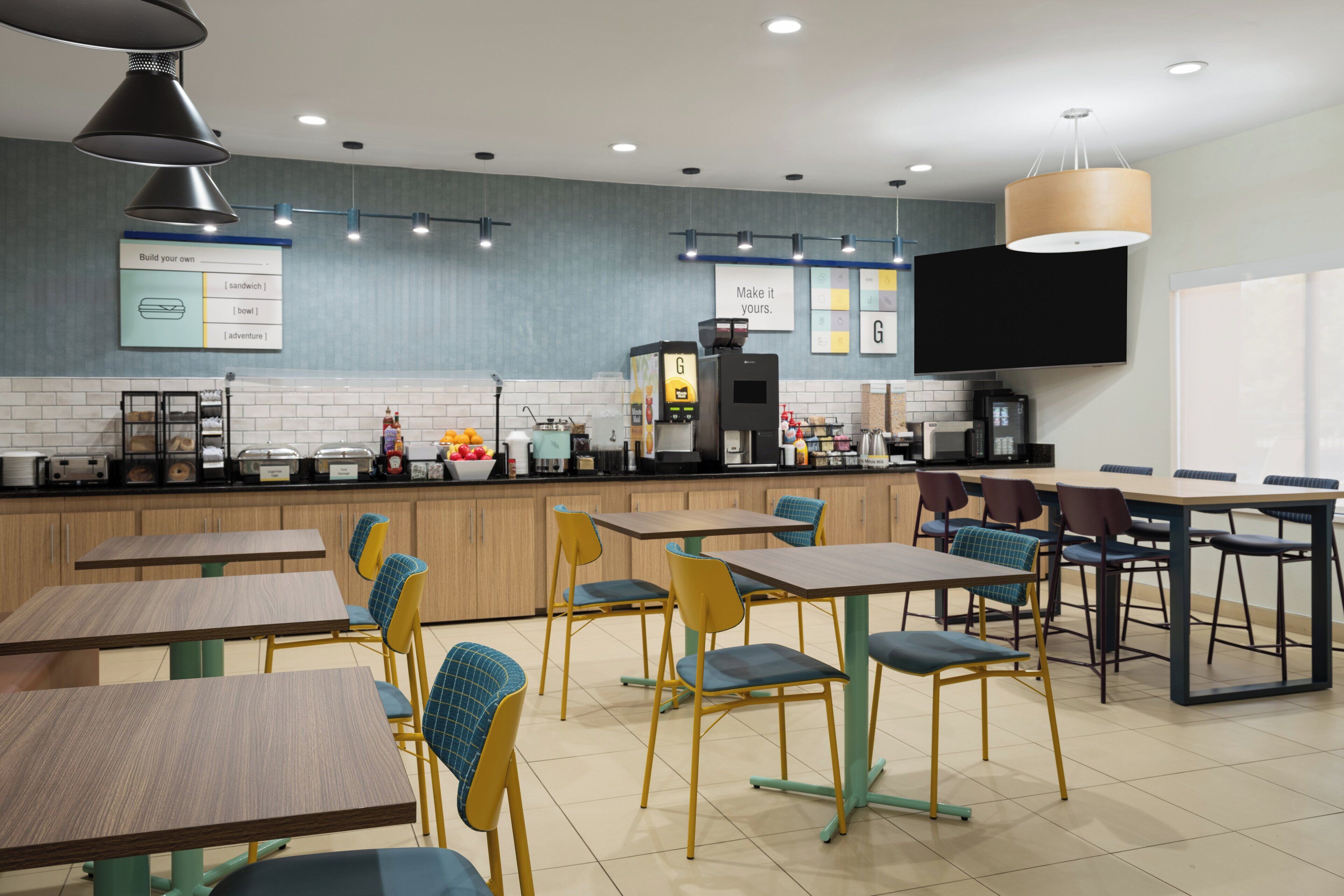 A modern cafe with multiple seating areas, a coffee machine, and a menu board.