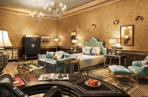 A luxurious bedroom with a large bed, two side tables, a chandelier, and a classic chandelier.