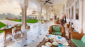A luxurious hotel lobby with a spacious open area, elegant furniture, and a view of a distant building.