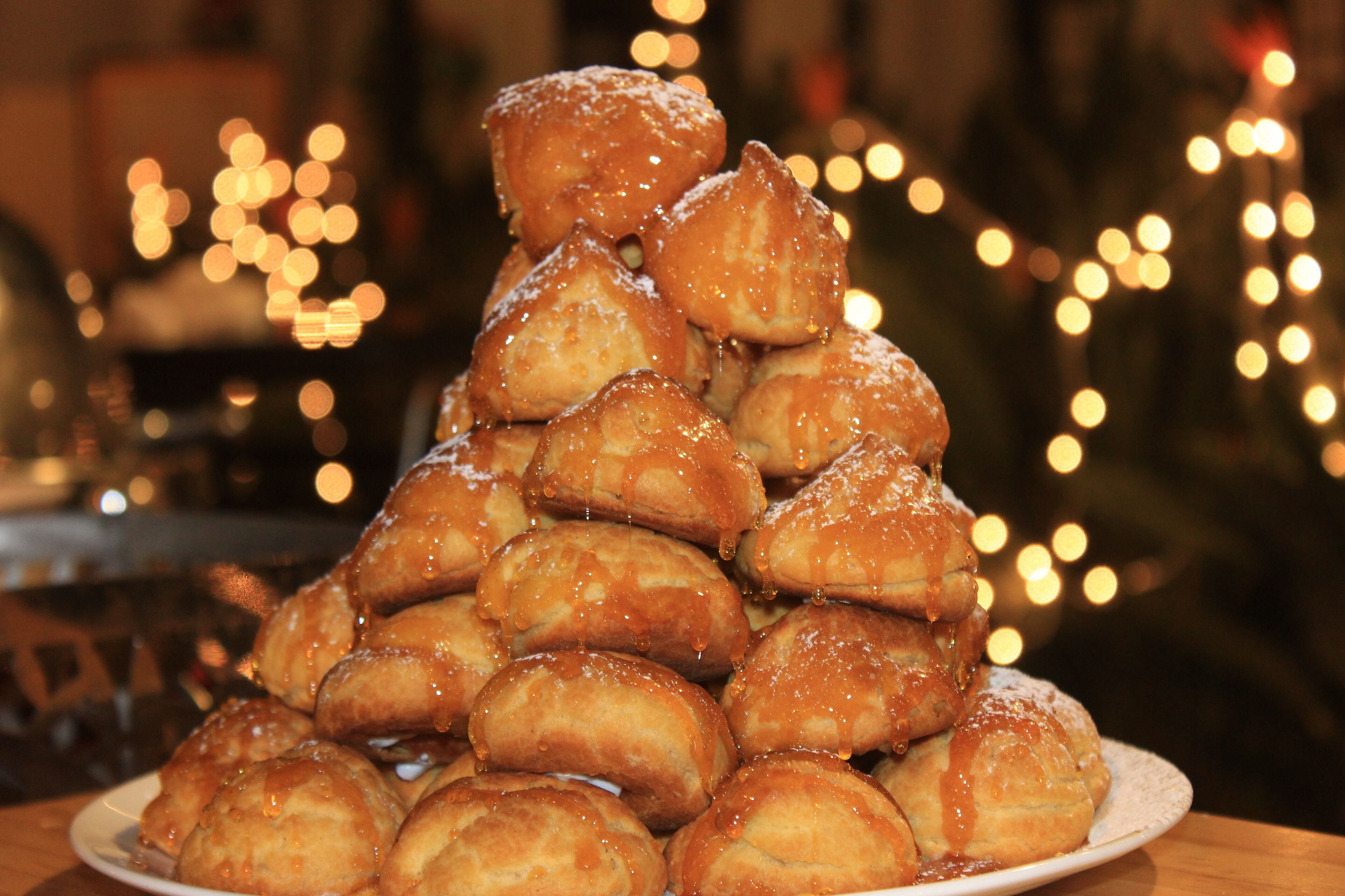 A plate of glazed pastries arranged in a pyramid.