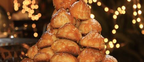A plate of glazed pastries arranged in a pyramid.