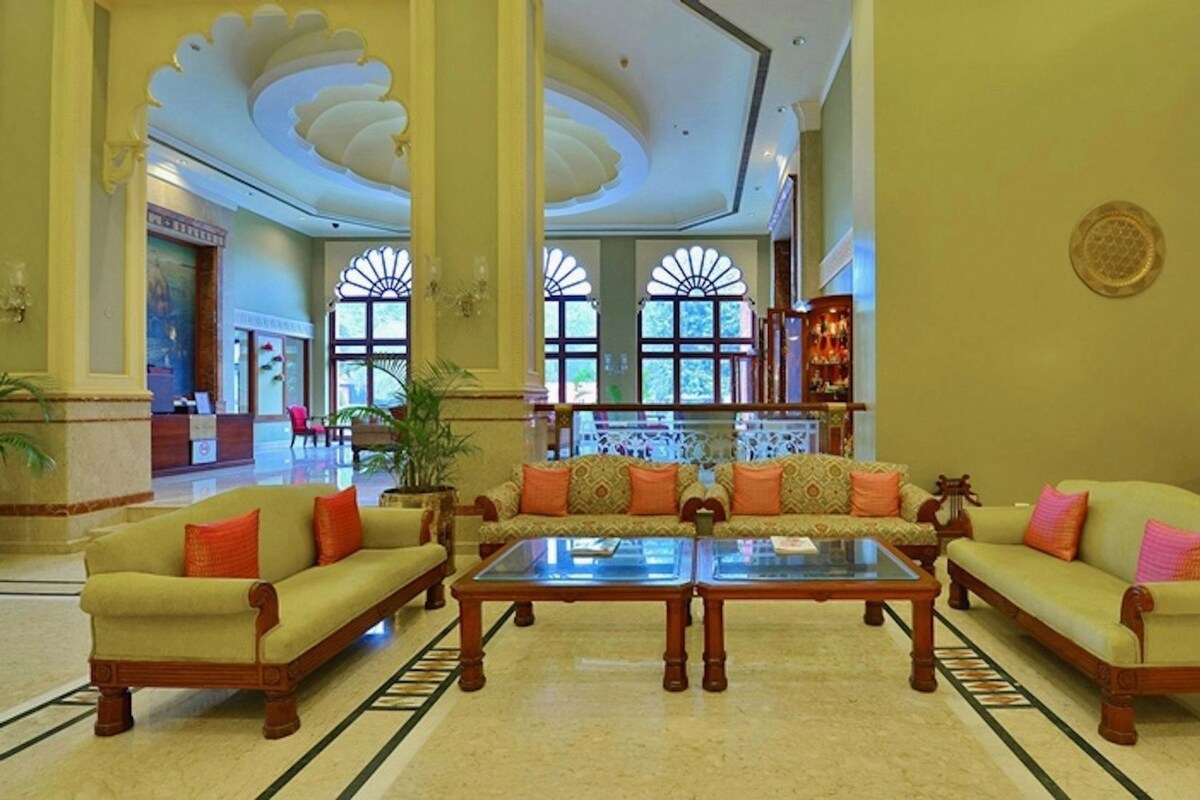A lobby with two sofas, a coffee table, and a reception desk.