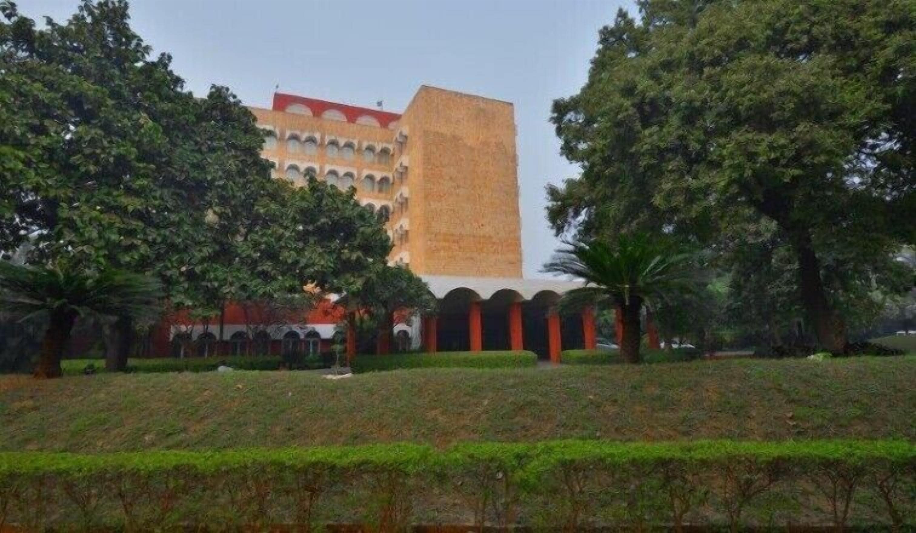 A building with a tall central tower and arched structures.
