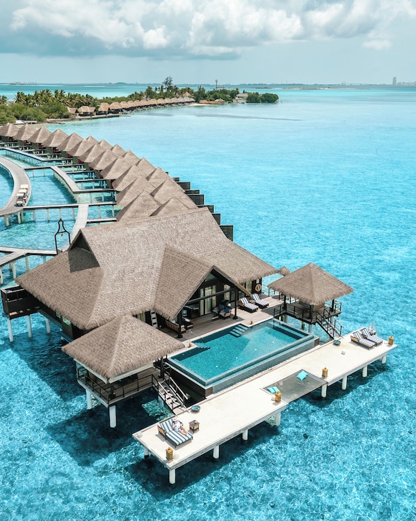 An overwater bungalows with infinity pools, a lounge area, and a view of the ocean. - Taj Exotica Resort And Spa (Emboodhu Finolhu)