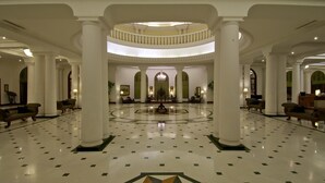 A spacious lobby with a central circular area, large white columns, and a polished floor with geometric patterns. - Taj Mahal Lucknow (Lucknow)