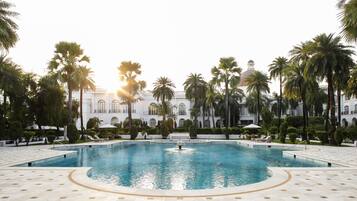 Outdoor pool, pool umbrellas, lifeguards on site