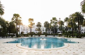 Outdoor pool, open 7:00 AM to 7:00 PM, pool umbrellas