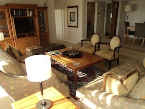 Relax in this inviting living room with a comfortable sofa, coffee table, and floor lamp.