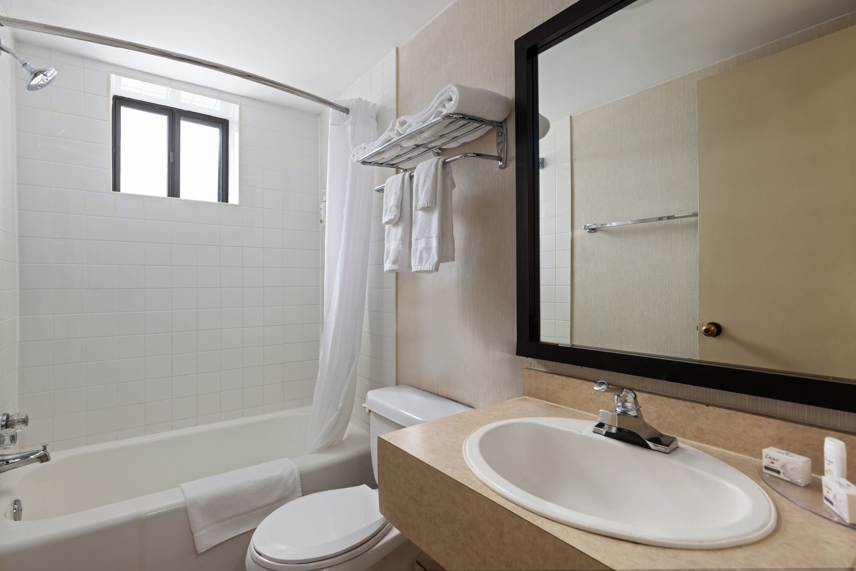 A modern bathroom with a bathtub, toilet, and sink.