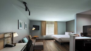 A hotel room with a desk, a bed, a sofa, and a small table. - TownePlace Suites by Marriott Baton Rouge South (Baton Rouge)
