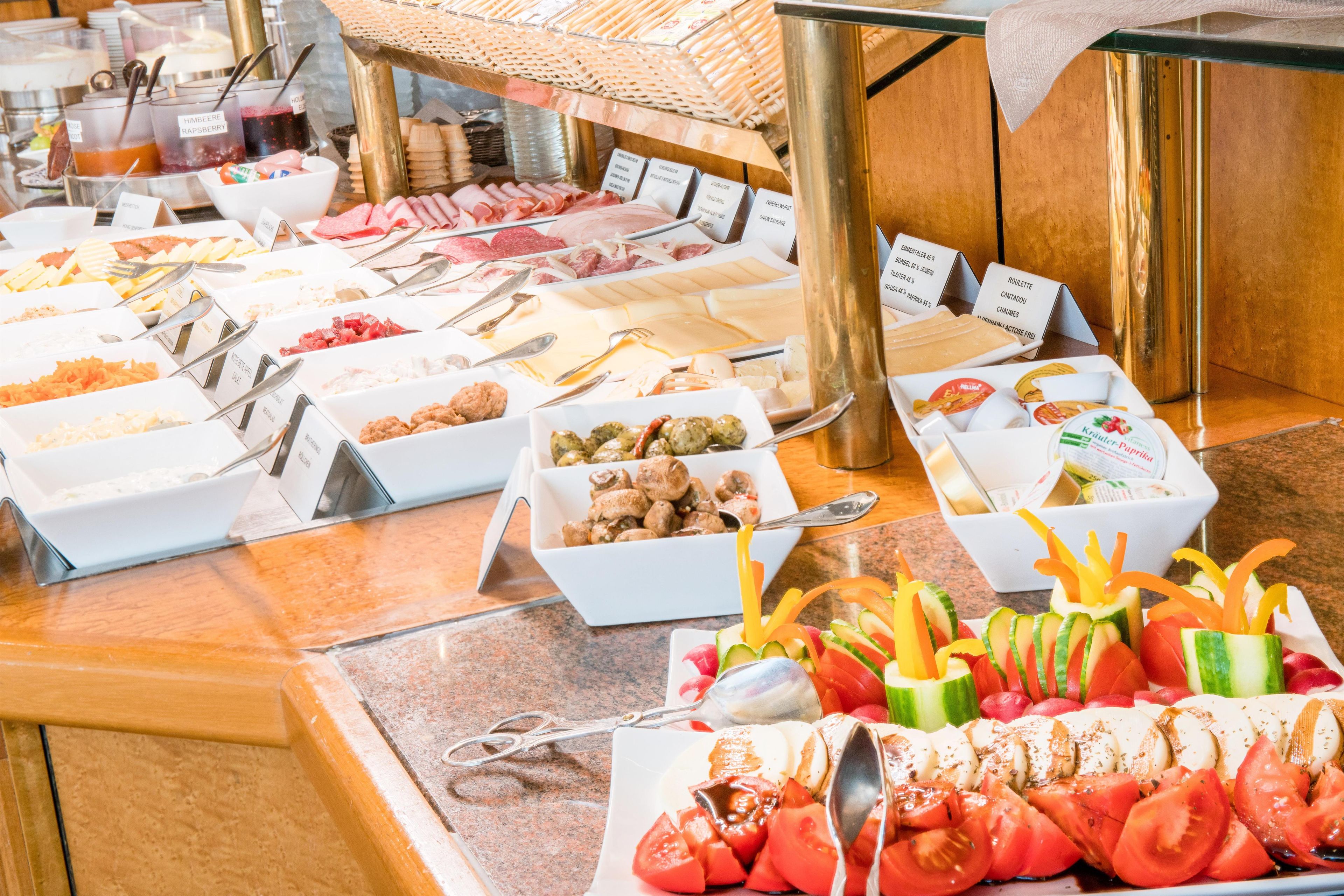 A buffet with various food options and utensils.