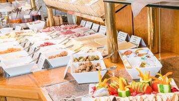 A buffet with various food options and utensils.