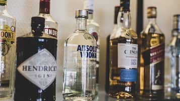 A variety of liquor bottles on a shelf.