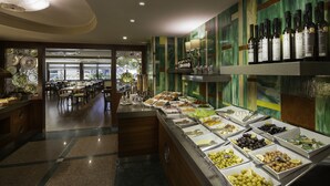 A buffet area with various food options and a wine selection.