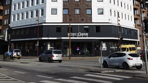 Un hôtel à plusieurs étages, doté d’une architecture moderne et d’une enseigne bien visible sur sa façade.
