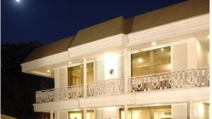 A two-story building with a balcony, large windows, and a visible logo on the facade. - Hotel Diplomat (New Delhi)