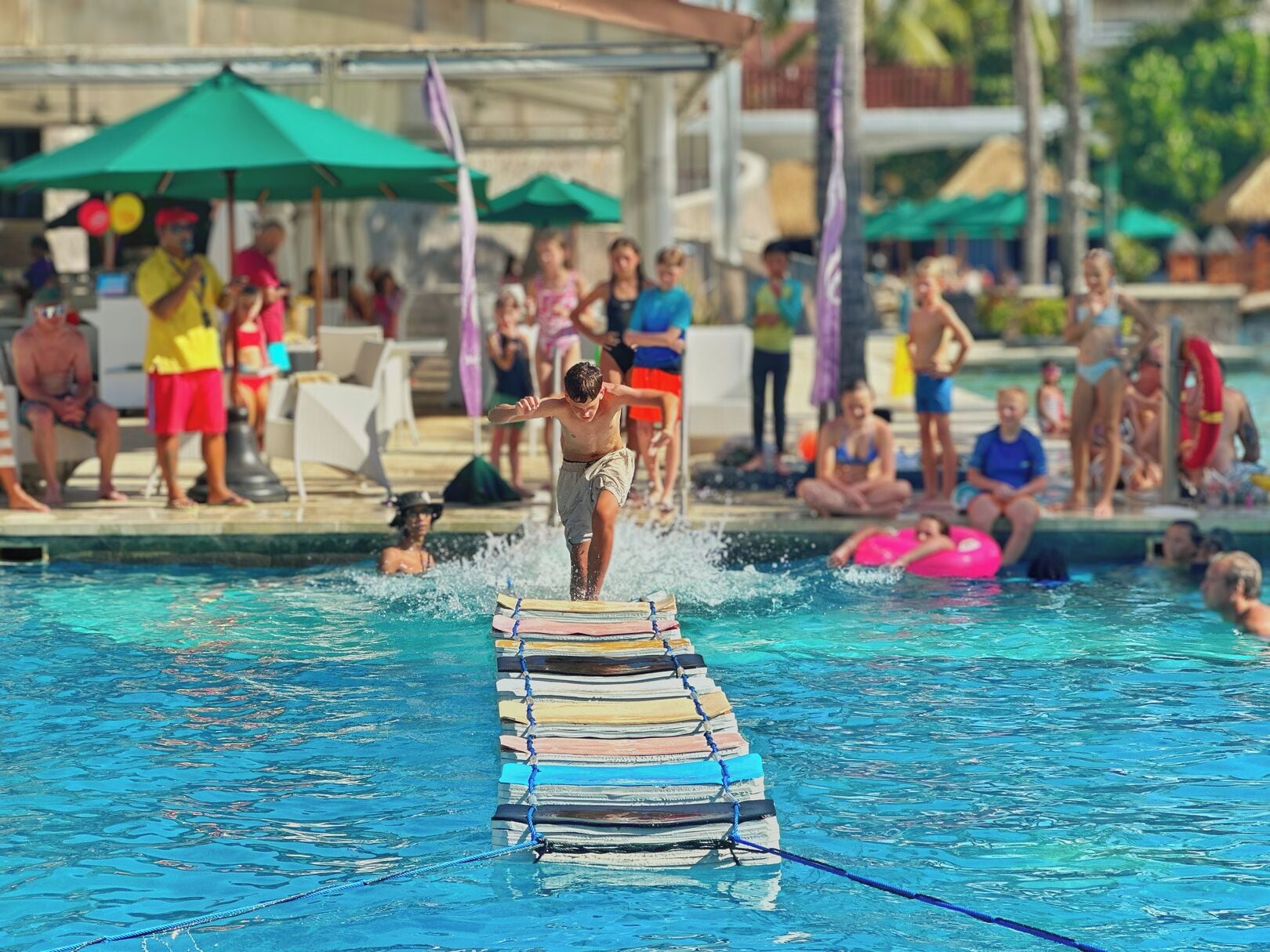 A swimming pool with a person standing on a floating platform.