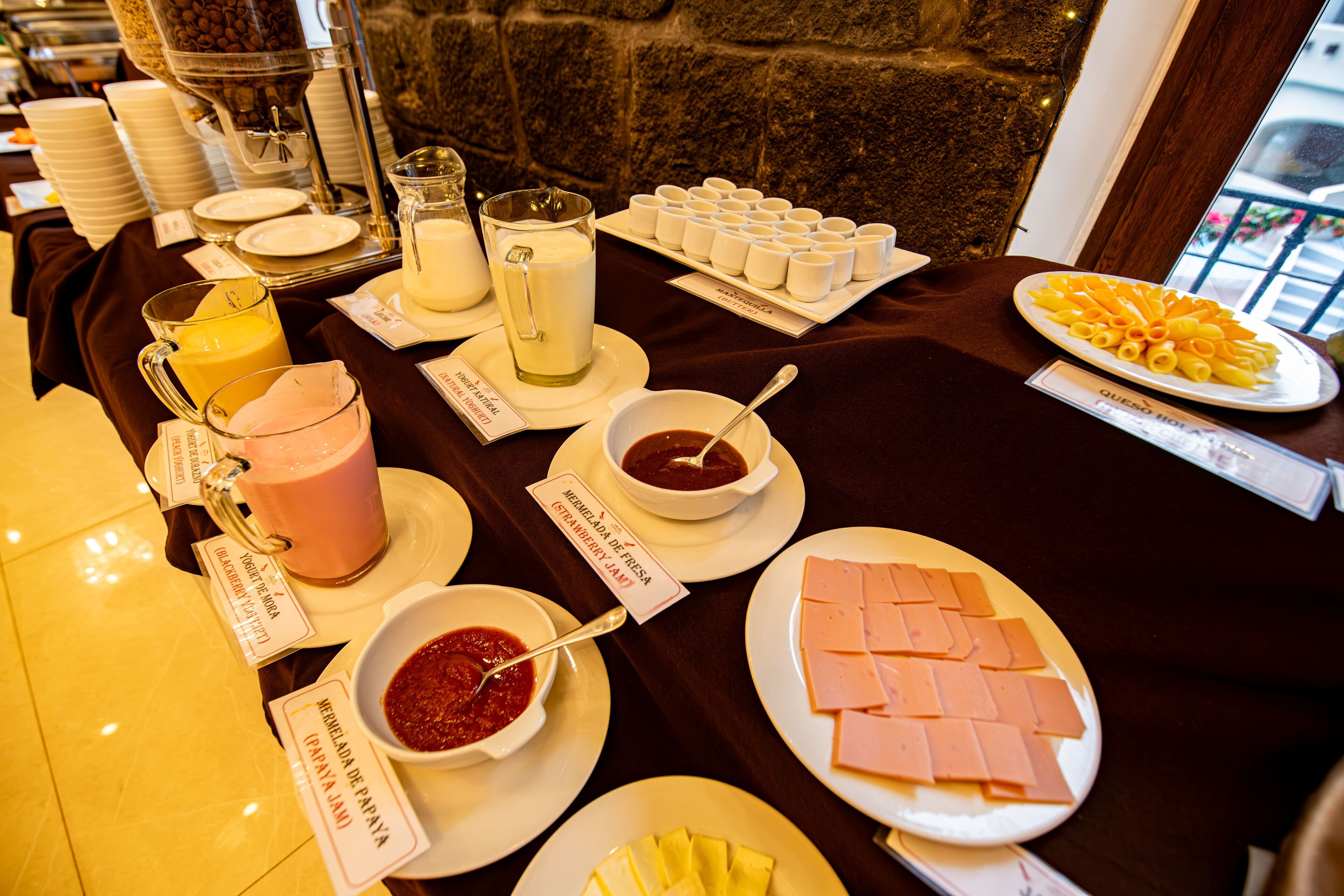A buffet table with various food items and beverages.